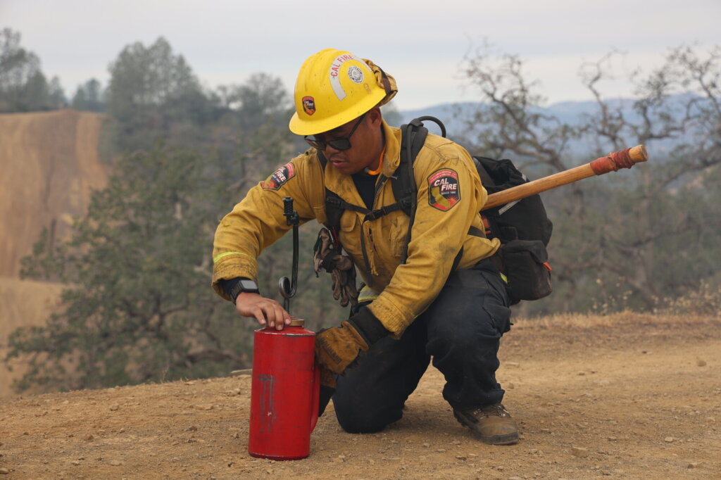 firefighter preparing a gas tank for prescribed fire