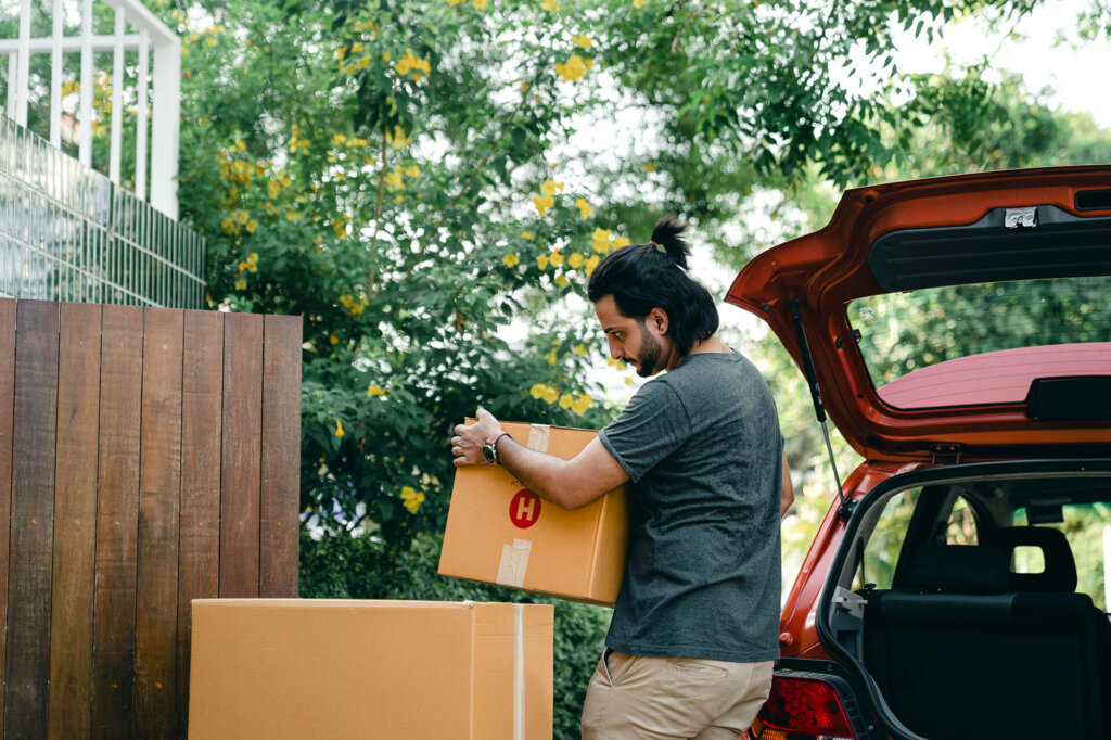 person moving boxes from the trunk of a car