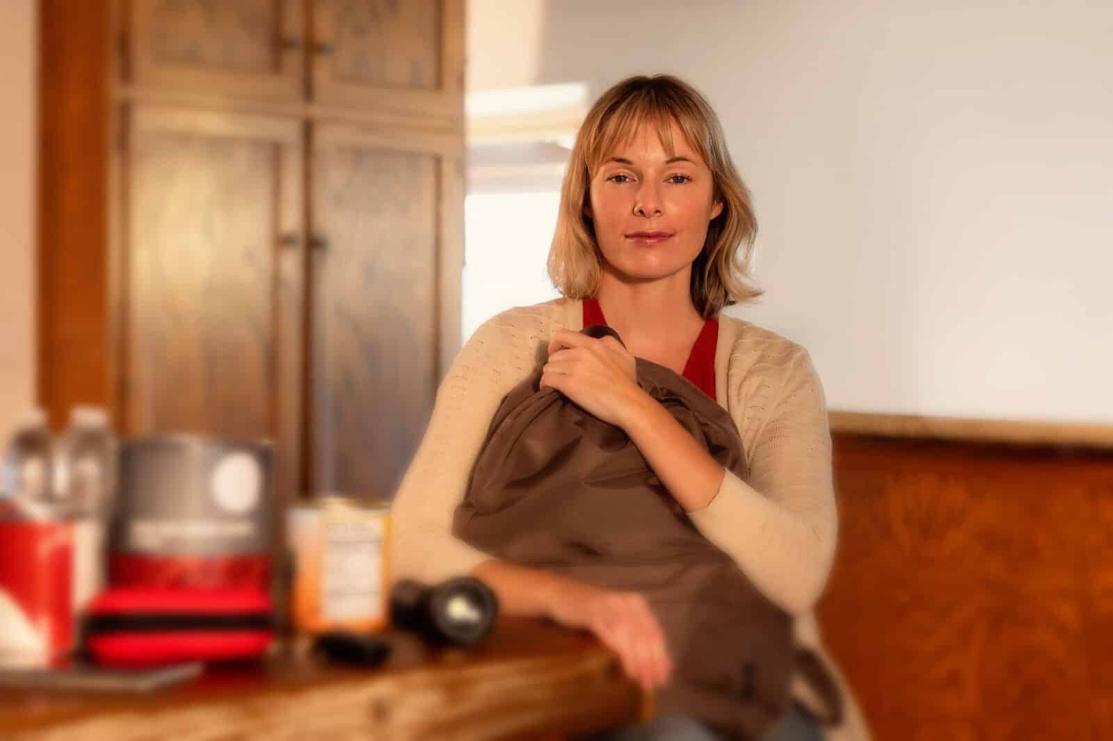 Woman holding emergency supply or Go Bag.